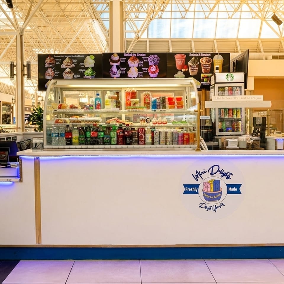Mini Delights food stall with drinks, snacks, and menu boards in a bright mall setting.
